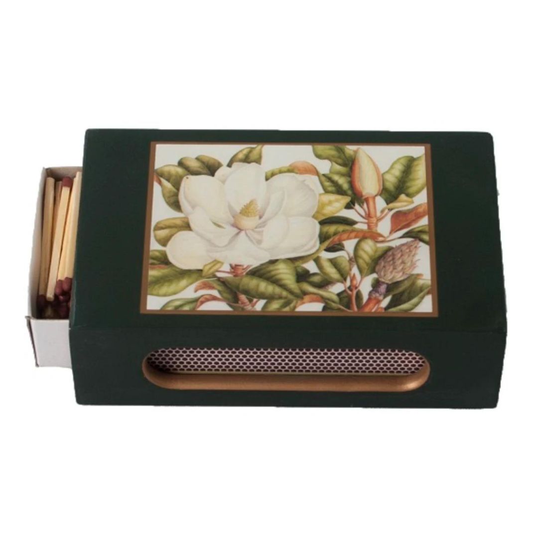 Magnolia on dark green matchbox cover with matches inside