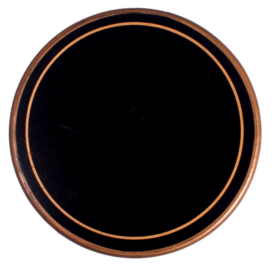 A circular black felt-backed table mat with a gold border.