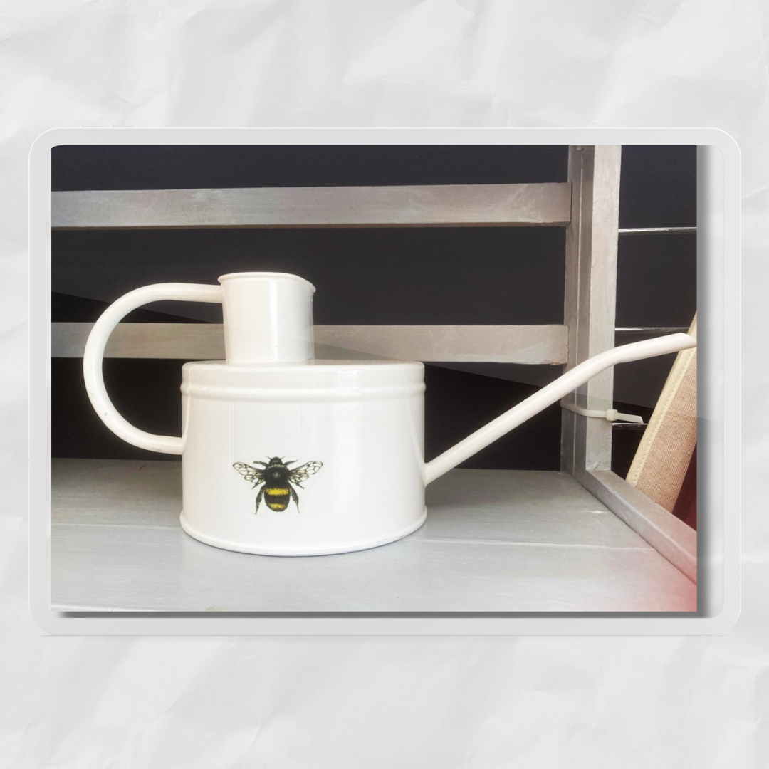 watering can with cream paint and bee motif, elegant handle and spout