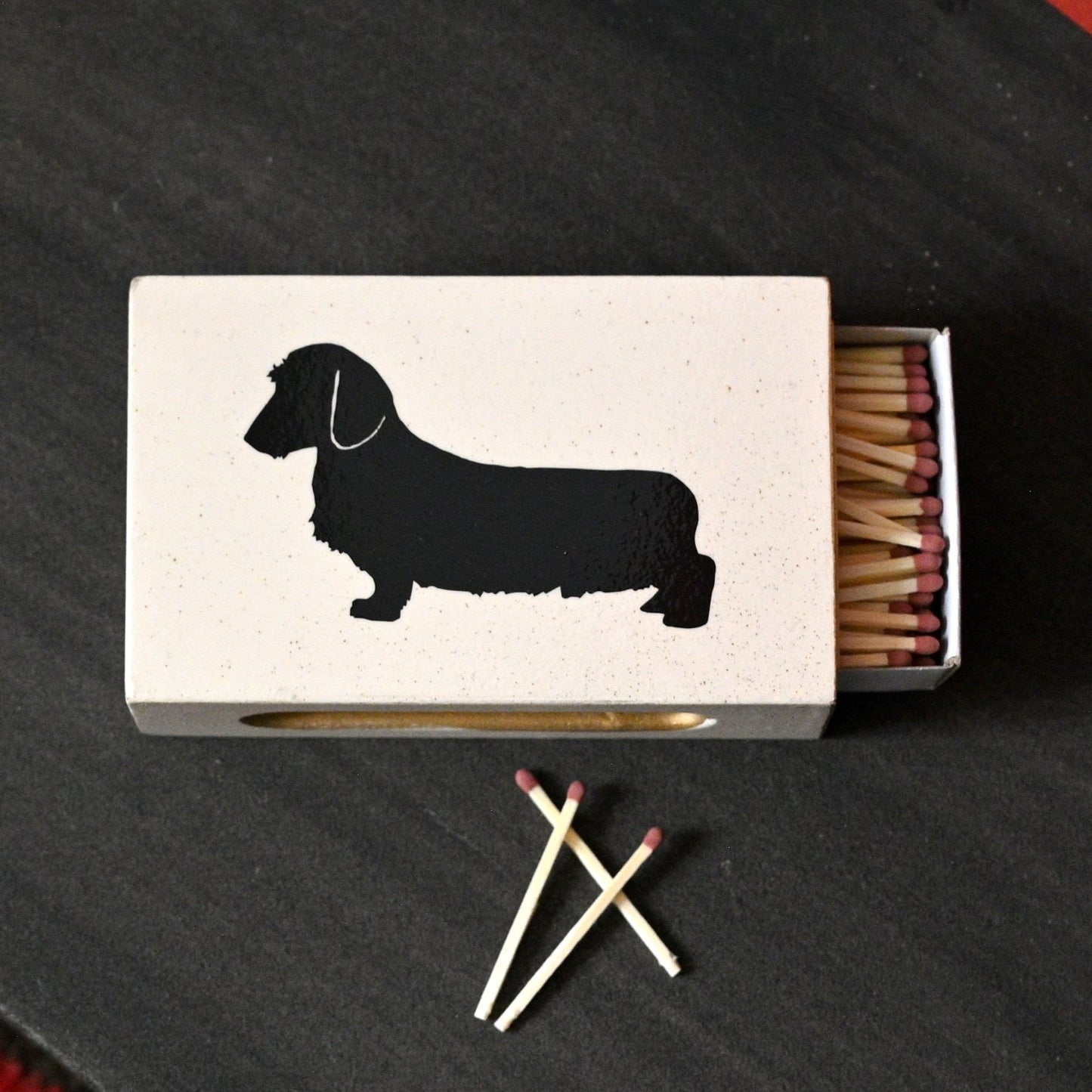 dachshund matchbox cover with matches in lifestyle