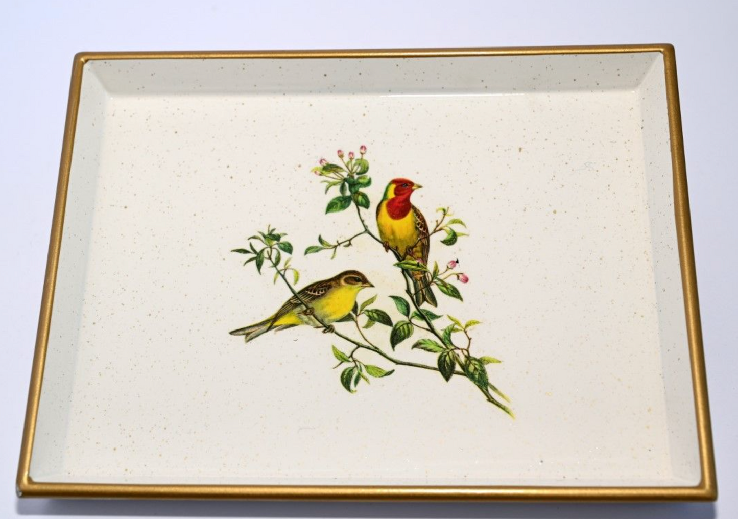 A decorative tray featuring a central illustration of two songbirds on a branch, surrounded by a gilded gold rim and a baize base.