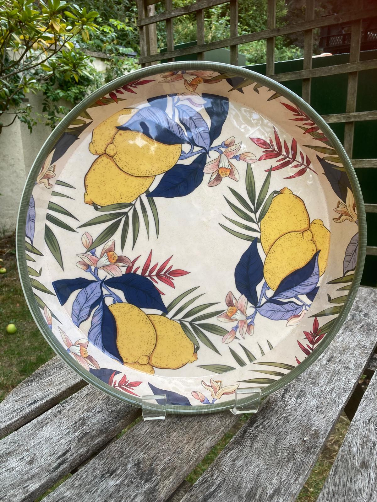 melamine tray in lemons design displayed upright on stand outside